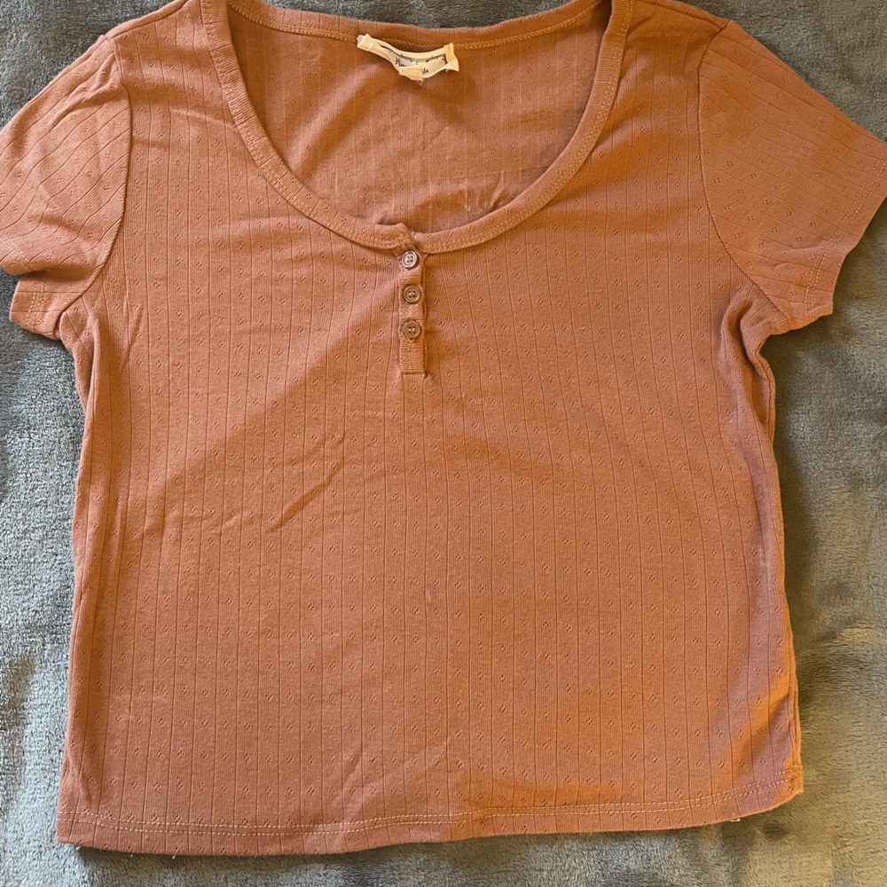 Short pink blouse with buttons.  Round neck